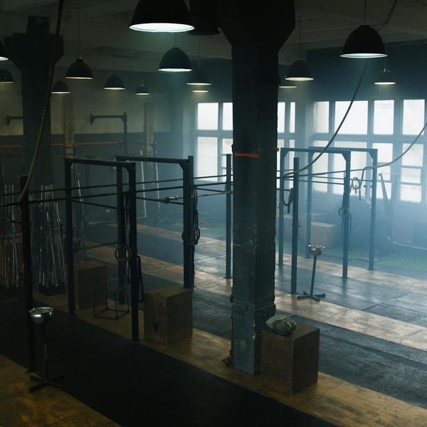 Man performing a functional strength exercise in a bright, clean space.